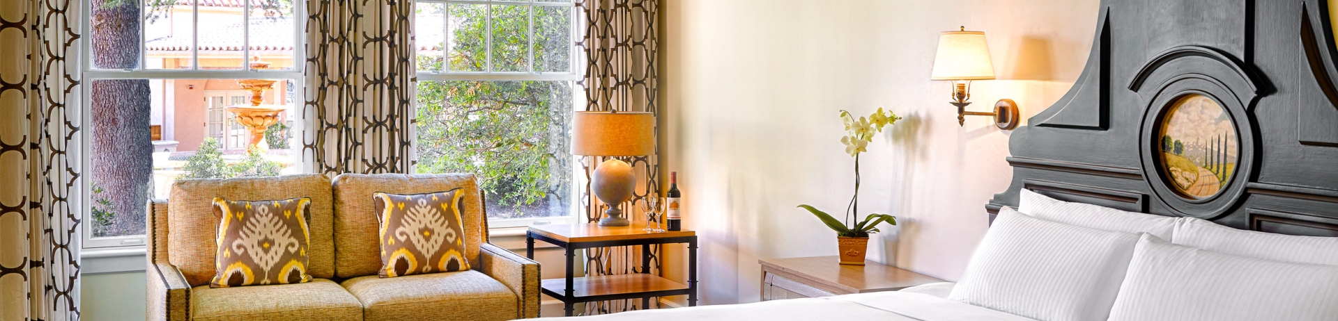 bedroom with small yellow sofa