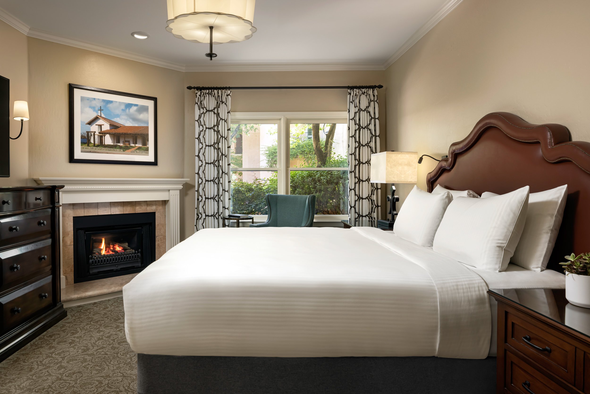 bedroom with fireplace and windows