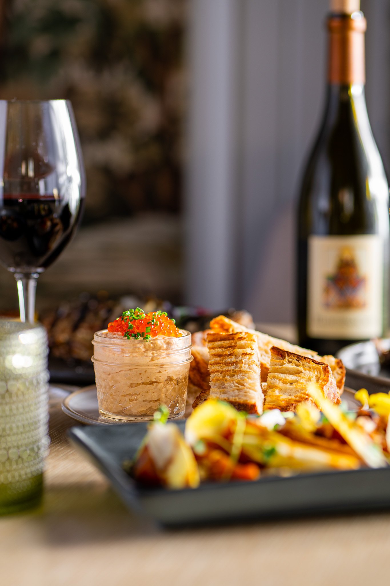 Plate of brightly colored food and bottle of wine at Sante Restaurant in Sonoma