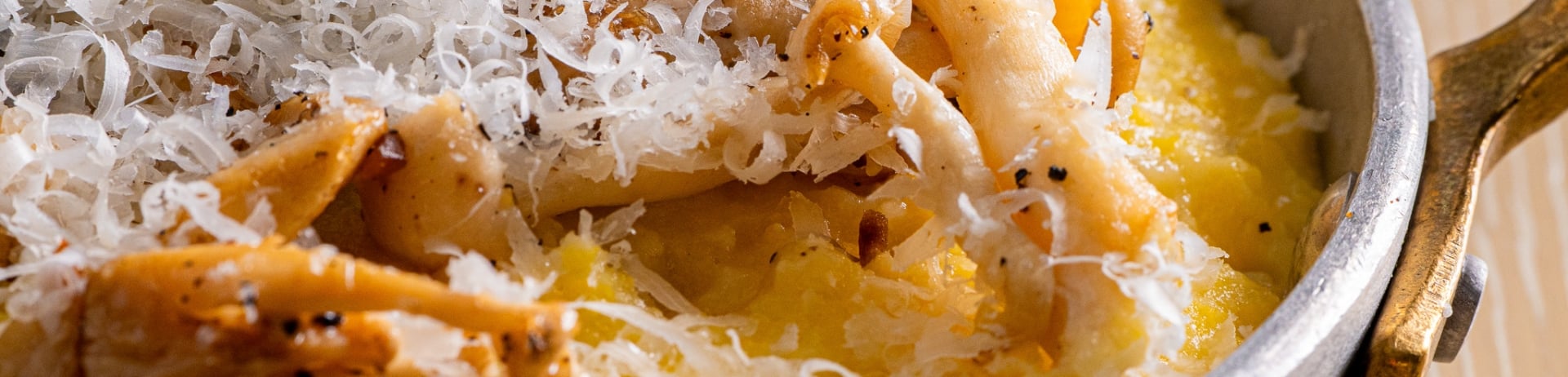 Bowl of polenta topped with freshly grated parmesan cheese at Sante Restaurant in Sonoma