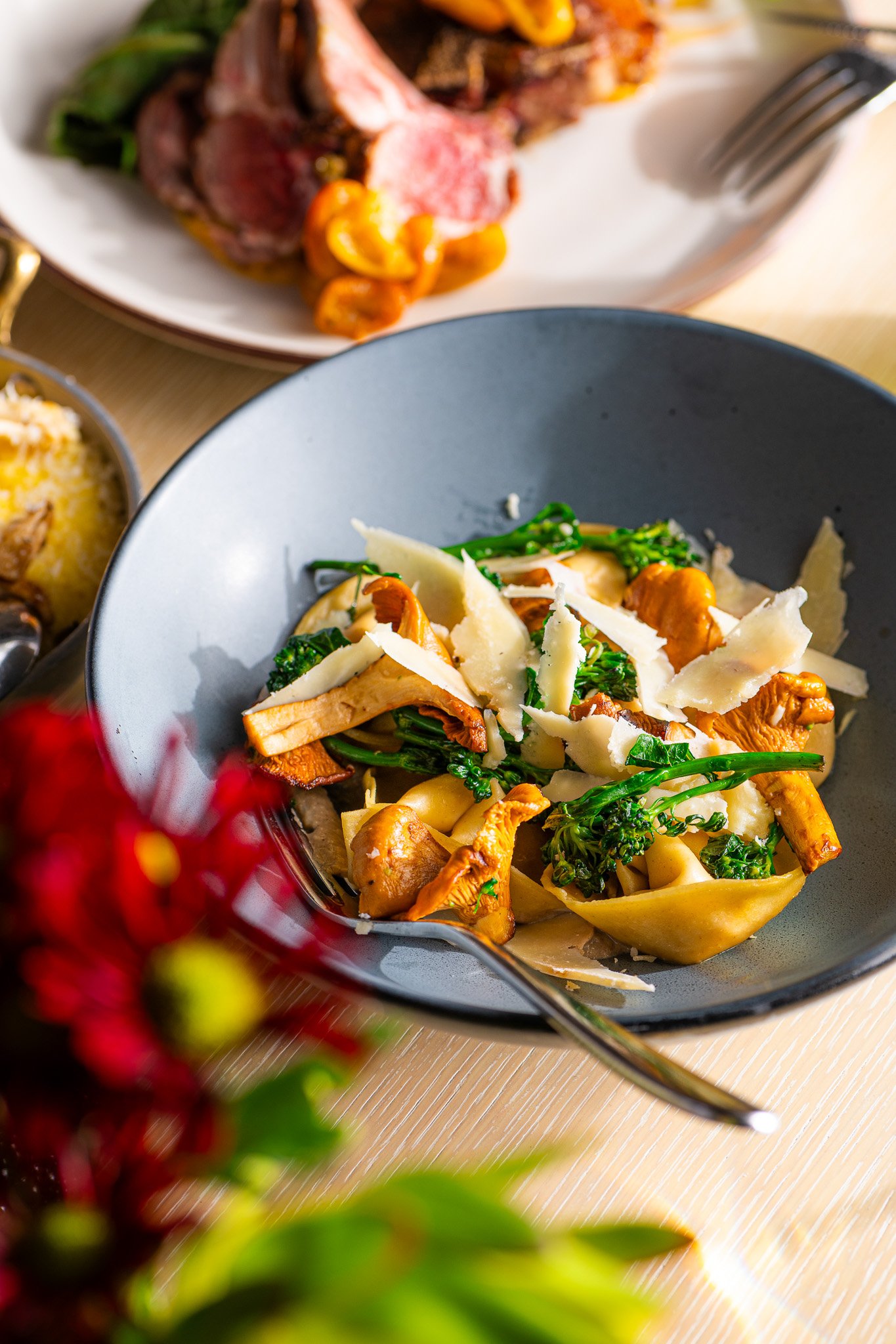 Bowl of tortellini pasta with mushrooms and grens
