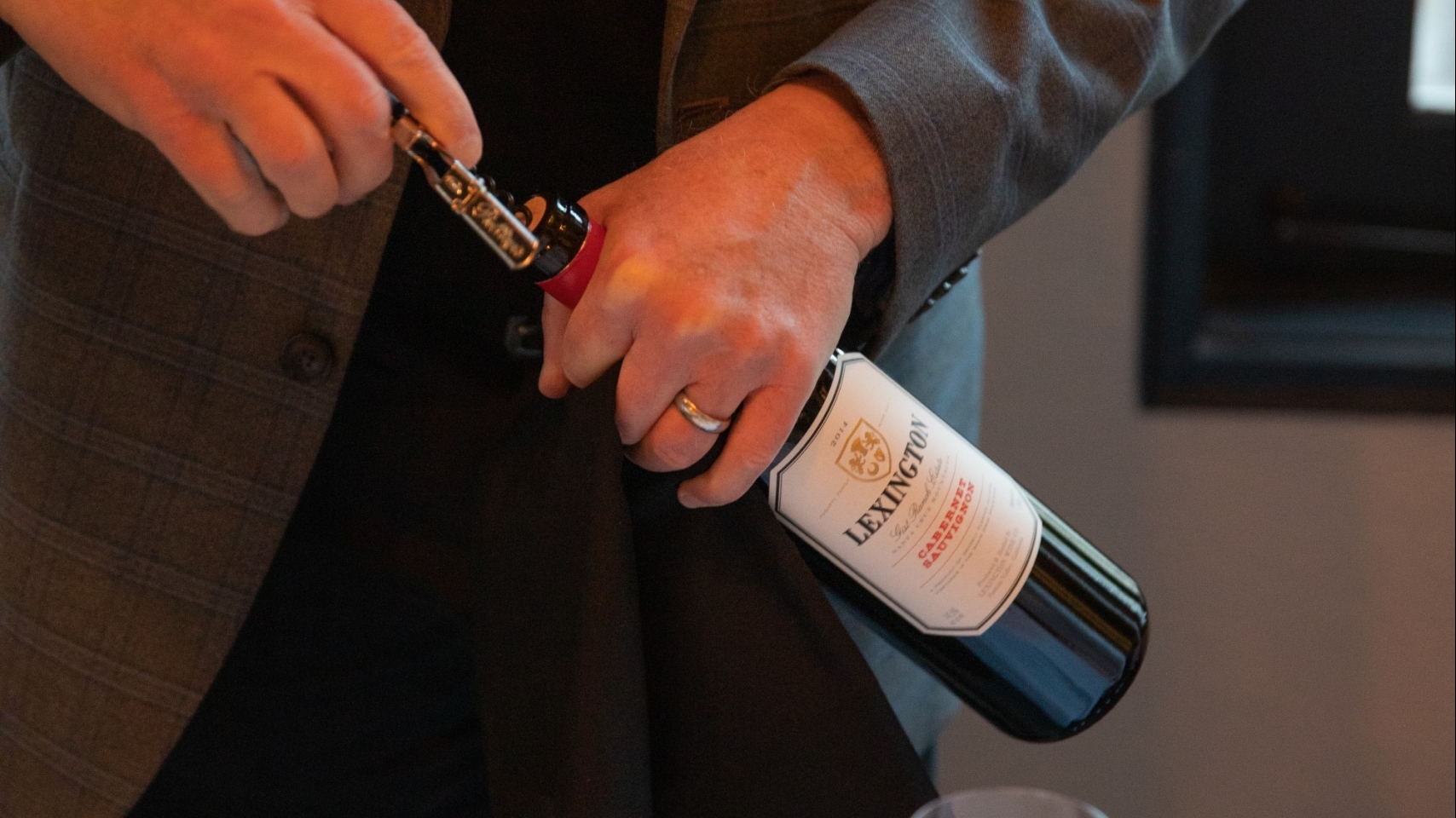 man opening bottle of wine