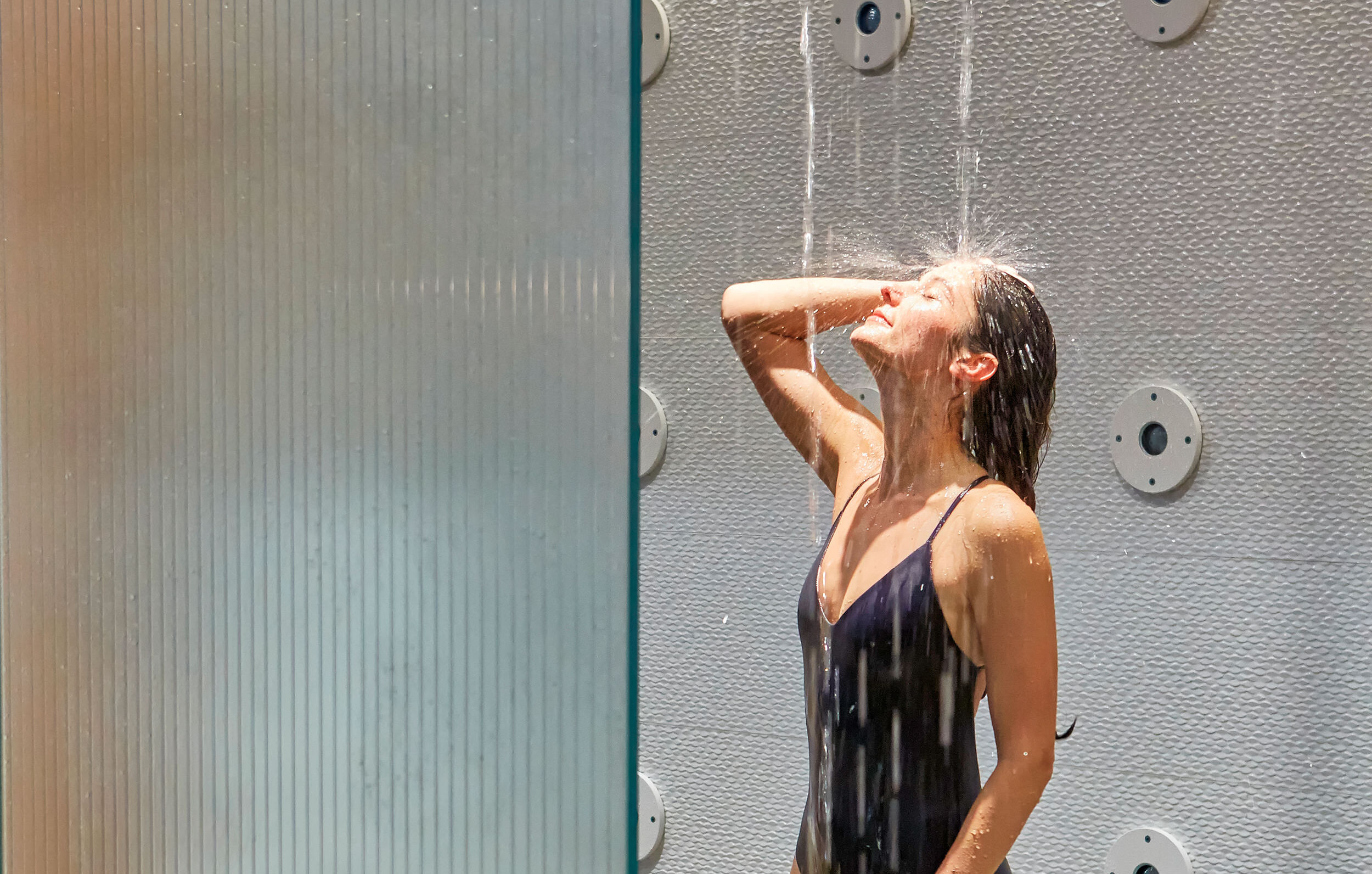 woman showering in bathing suit