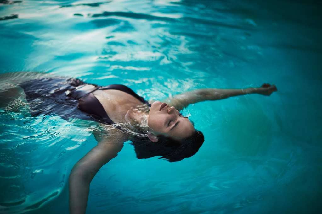 woman floating in a pool