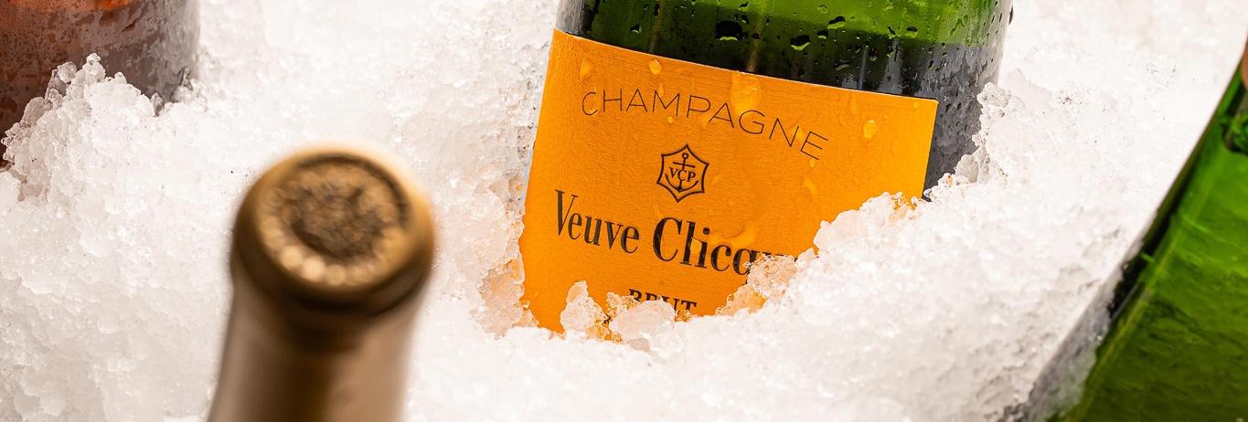 Bucket of ice filled with bottles of champagne