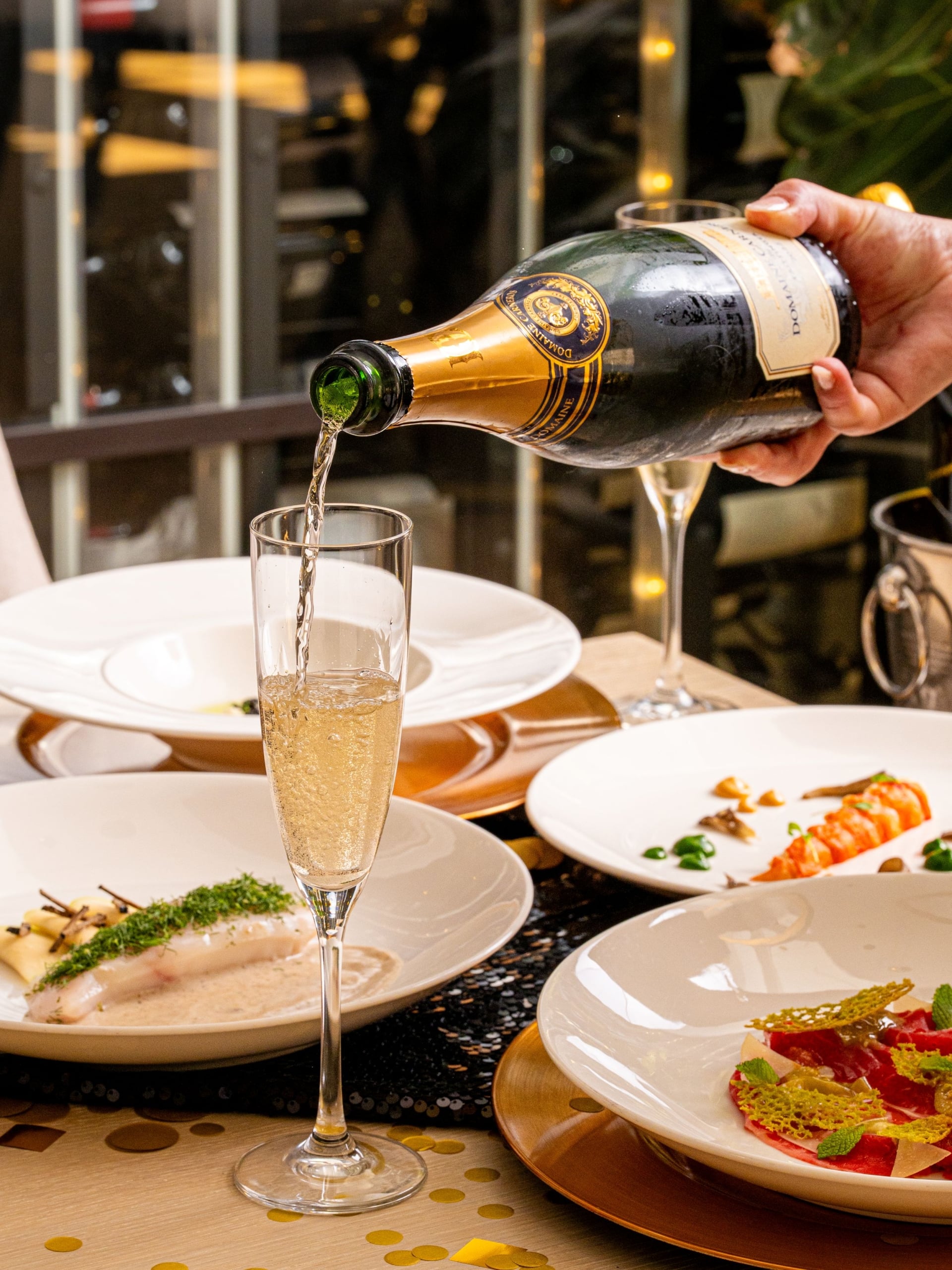 Pouring a glass of champagne at a decorative table