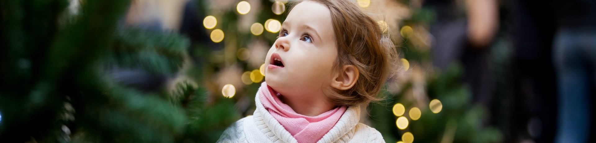 child looking at christmas lights