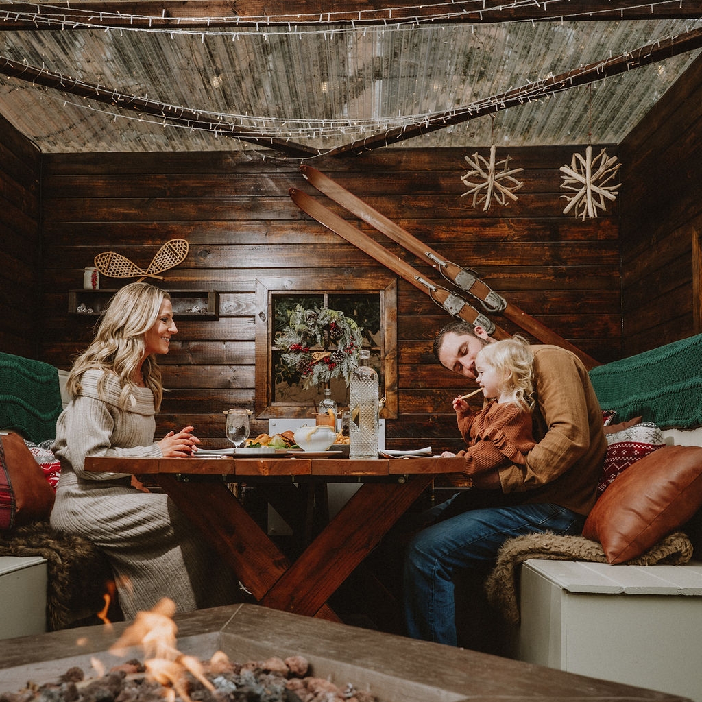 young family enjoying a holiday meal in a charming ski chalet