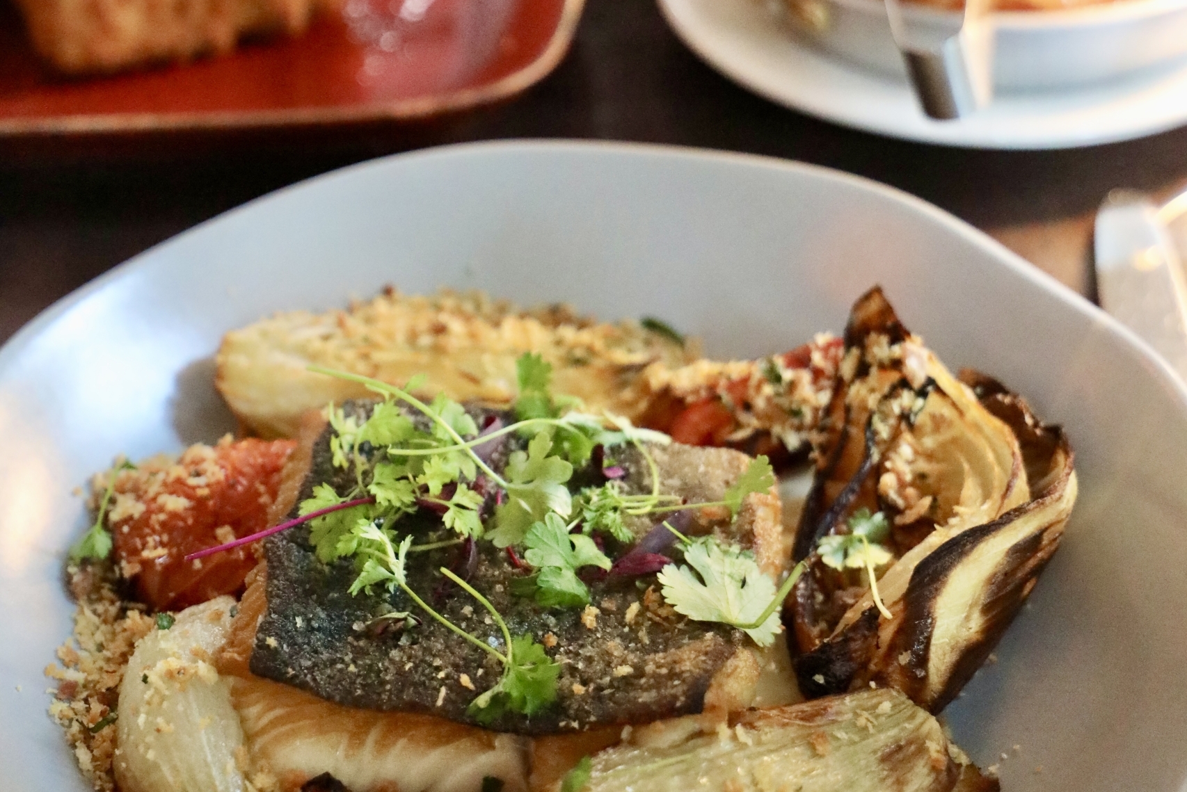 plate of black cod with fennel, tomatoes, cod and micro greens