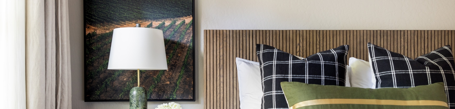 details of the gloria ferrer suite bedroom with floral arrangement on bedside table