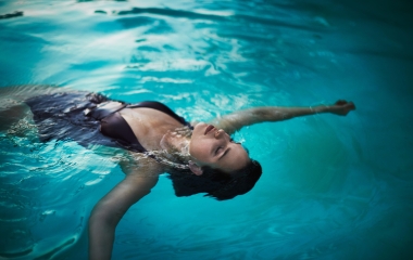 woman floating on her back in a pool