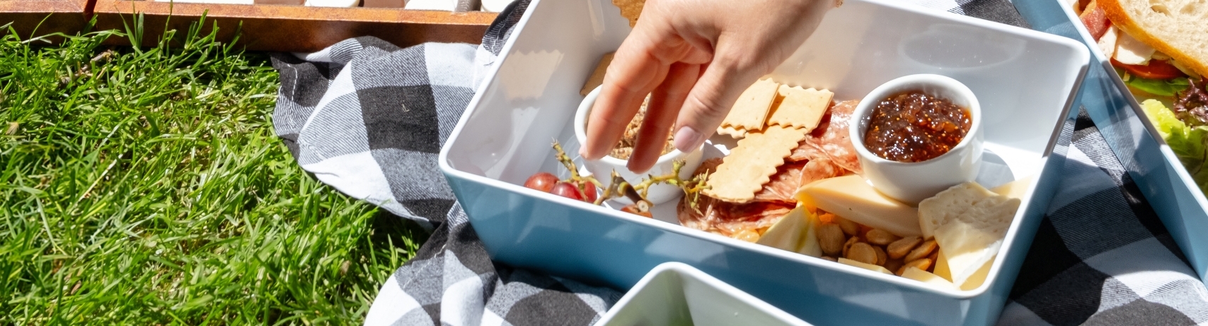 Array of picnic items, sandwiches, snacks and board games at Fairmont Sonoma