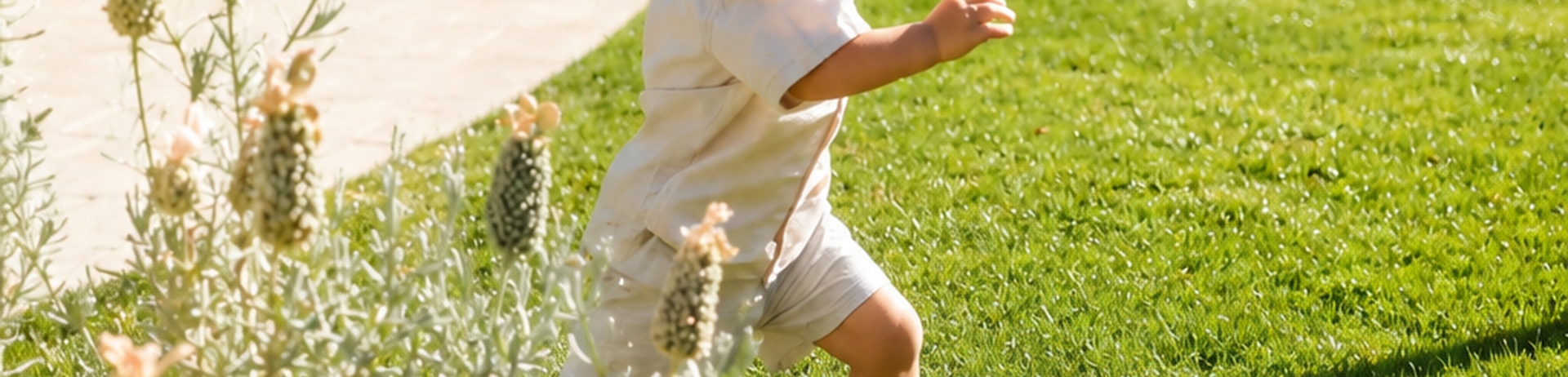 Young boy running on green grass at Fairmont Sonoma