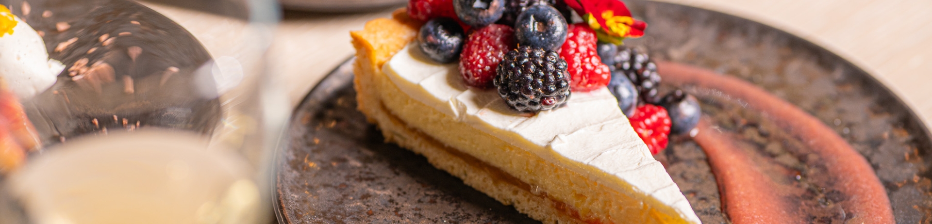 Vibrant dessert with fresh berries and a glass of wine