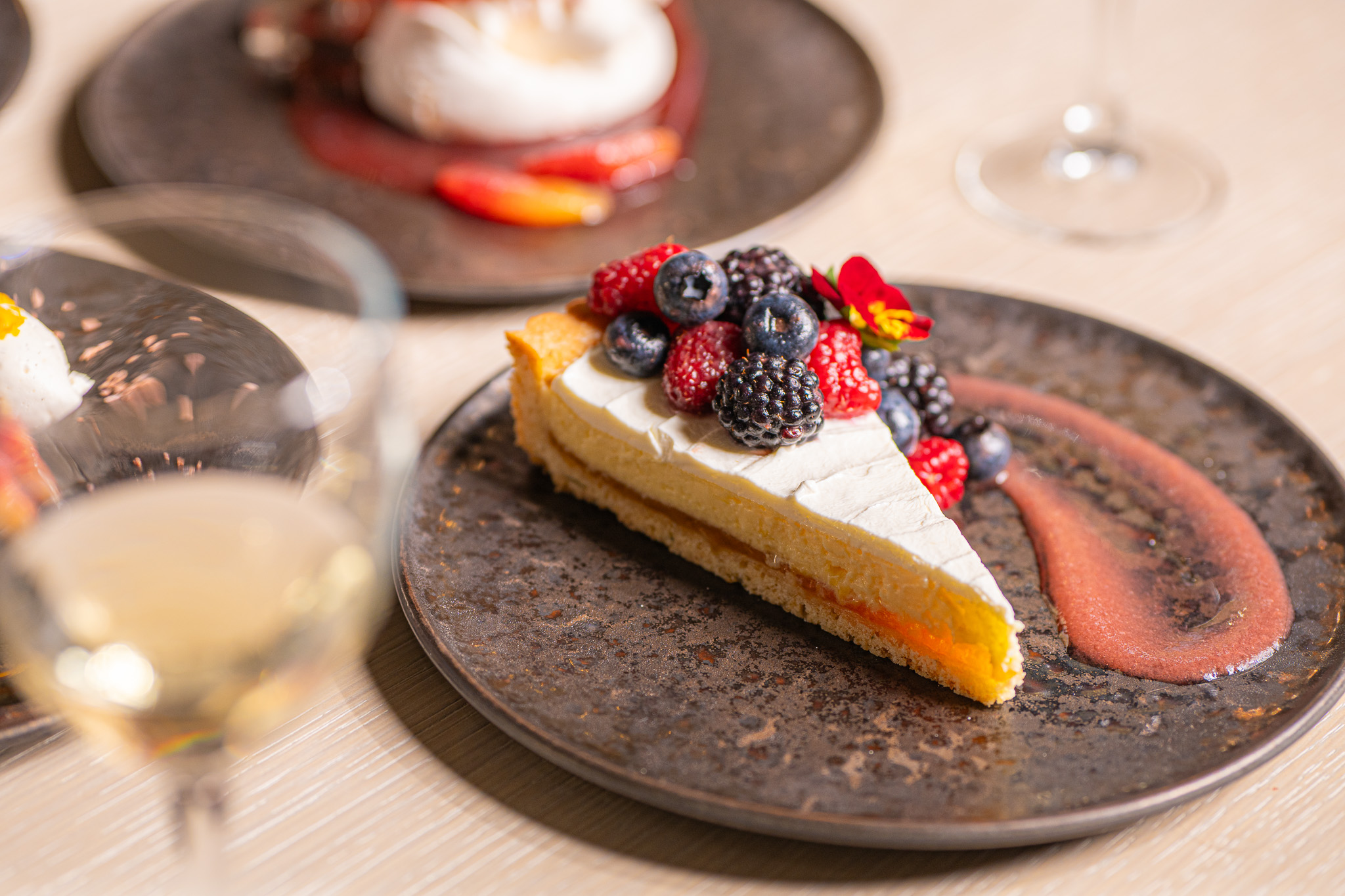 Vibrant dessert with fresh berries and a glass of wine