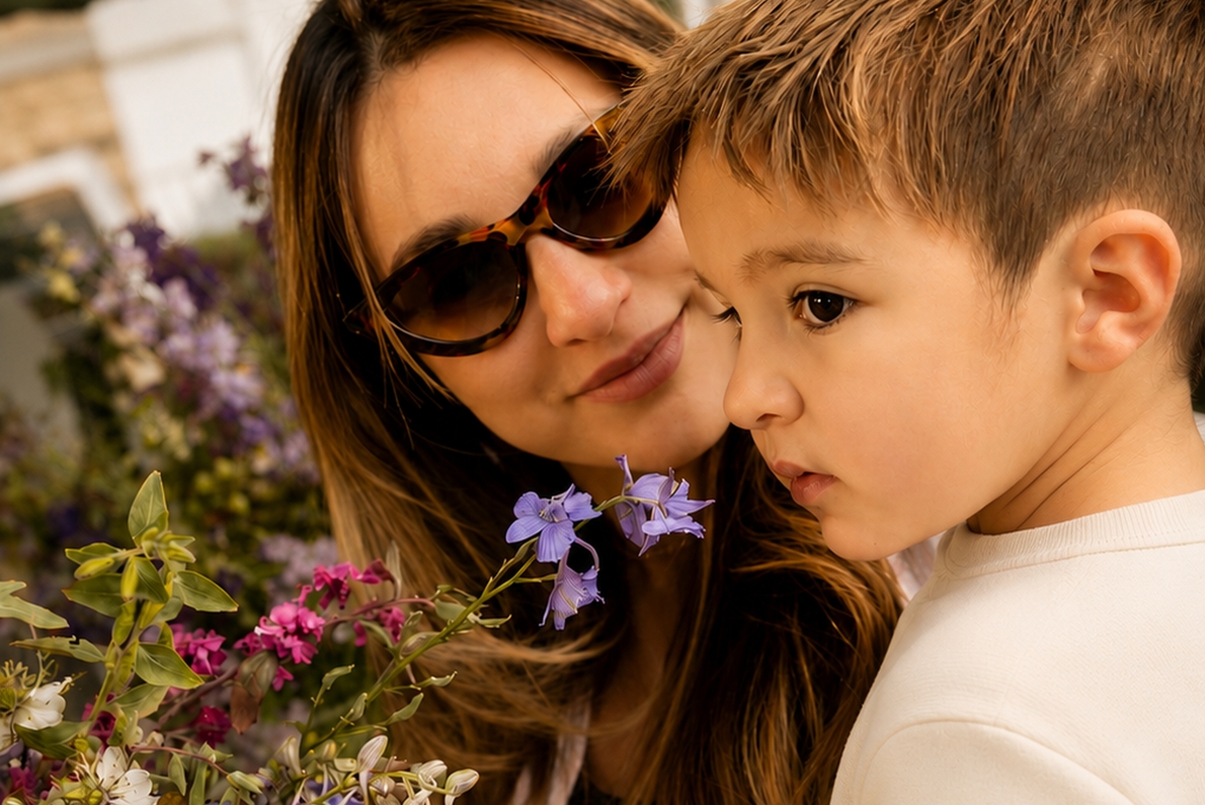 Young boy and mother looking at flowers at a farmers market in Sonoma